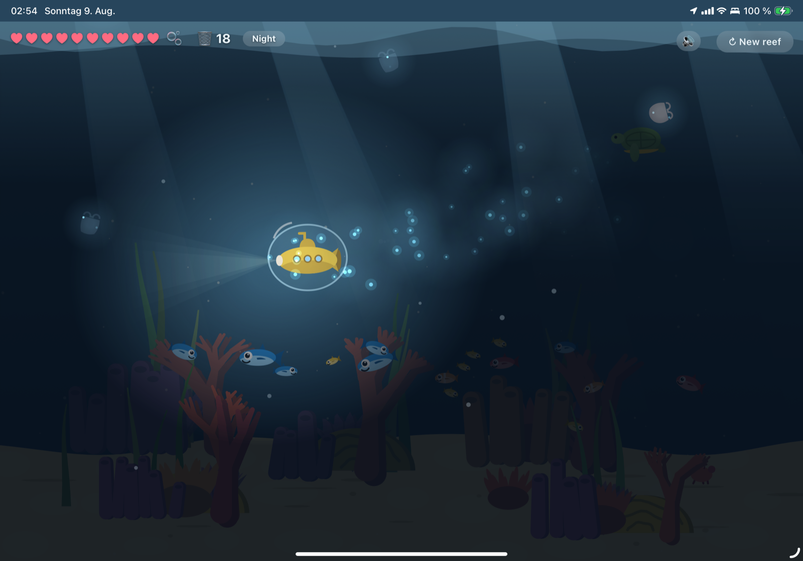 The night stage: the reef in deep blue-black, the submarine inside a wobbling bubble, glowing specks trailing behind it, a turtle and a floating coffee cup up in the dark.